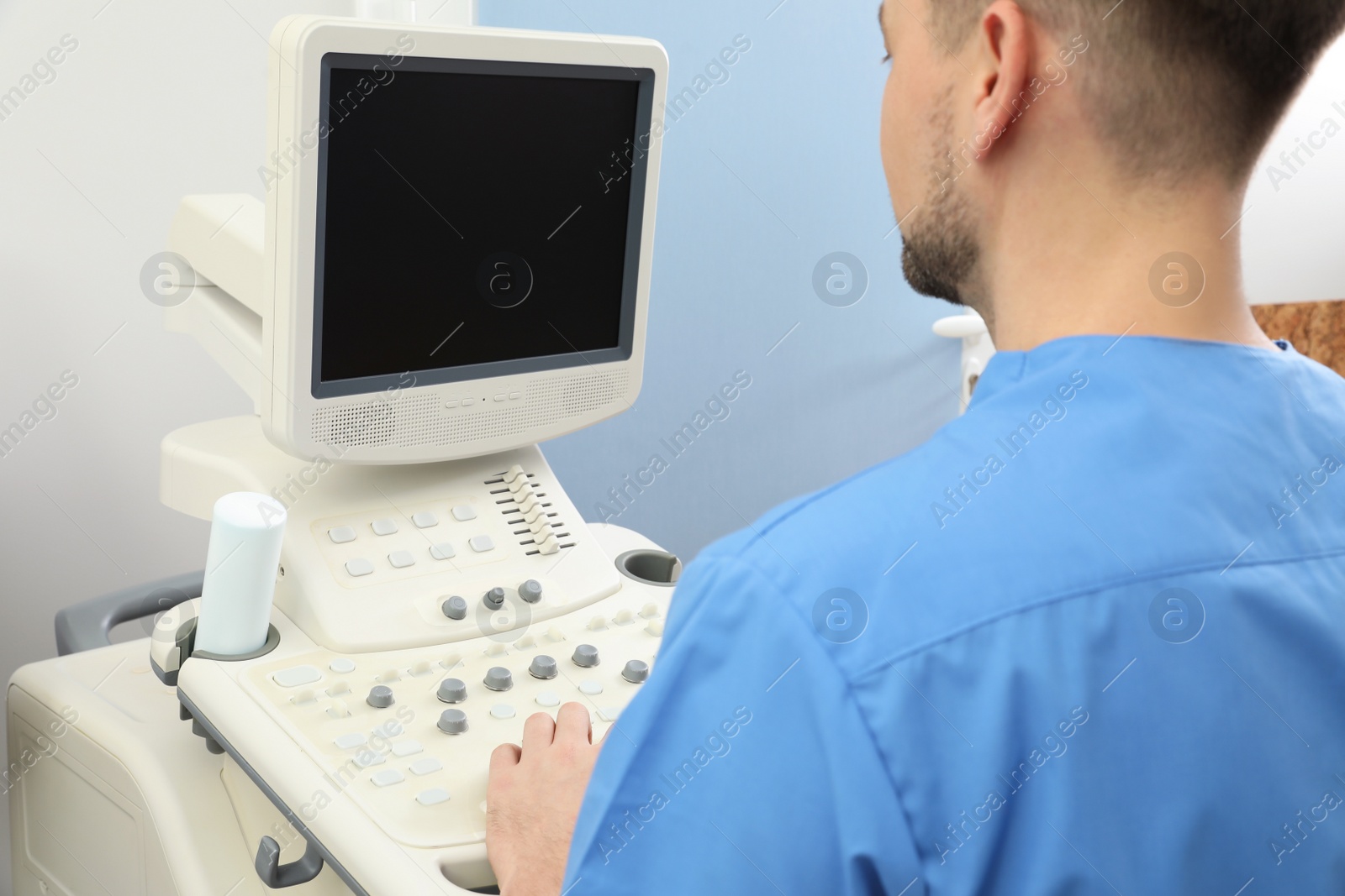 Photo of Sonographer operating modern ultrasound machine in clinic