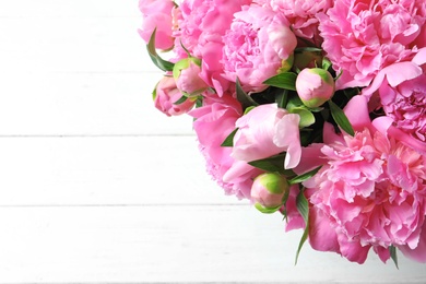 Photo of Beautiful fragrant peony flowers on light background