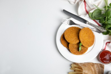 Photo of Delicious fried breaded cutlets served on white table, flat lay. Space for text