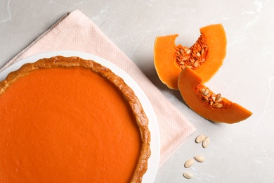 Flat lay composition with fresh delicious homemade pumpkin pie on light background