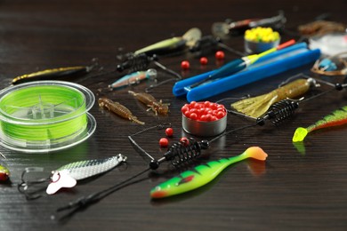 Photo of Fishing tackle on dark wooden background, closeup