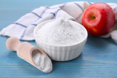 Photo of Sweet fructose powder and apple on light blue wooden table