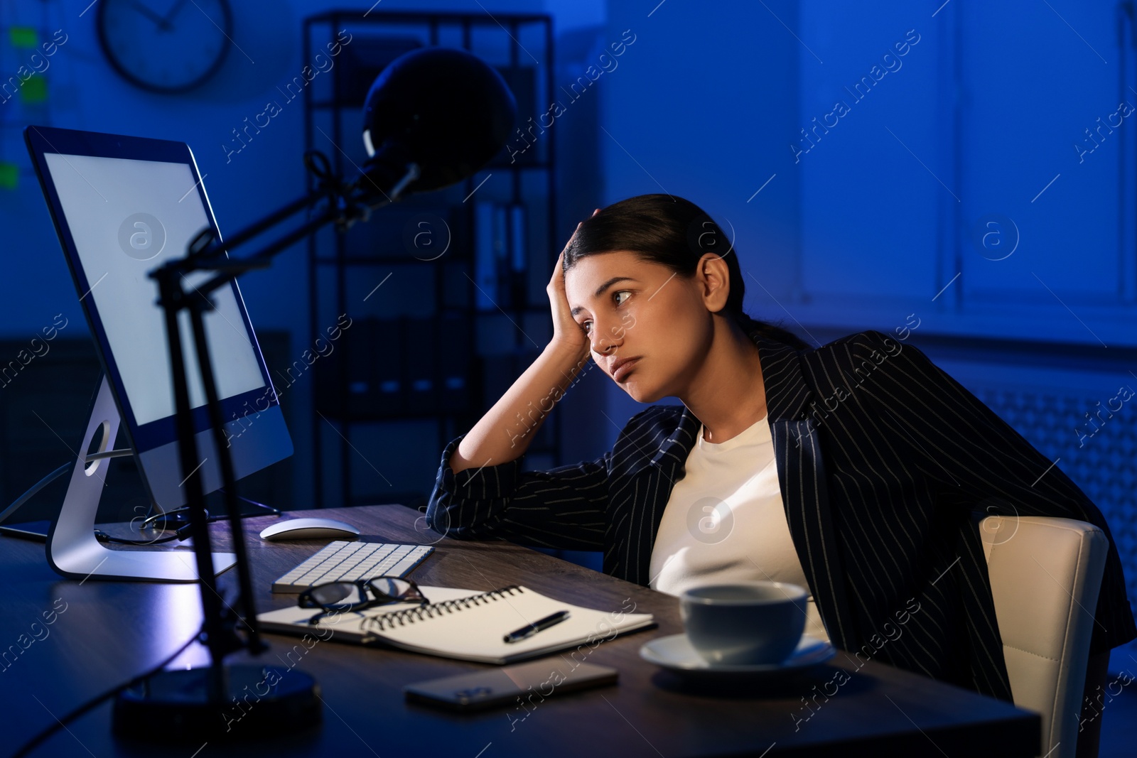 Photo of Tired businesswoman working at night in office