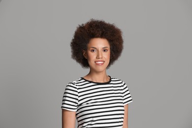 Photo of Portrait of beautiful young woman on grey background