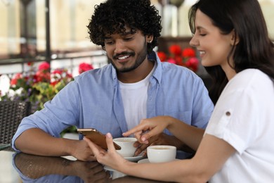 International dating. Happy couple spending time together in restaurant