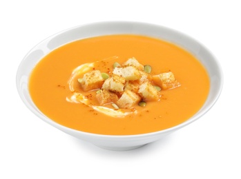 Photo of Tasty creamy pumpkin soup with croutons and seeds in bowl on white background