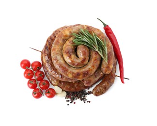 Rings of delicious homemade sausage with spices, chili pepper and tomatoes isolated on white, top view