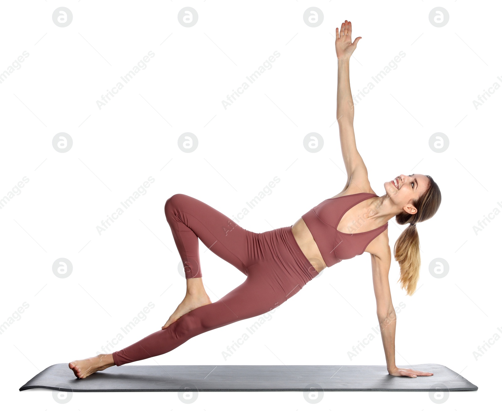 Photo of Young woman in sportswear practicing yoga on white background