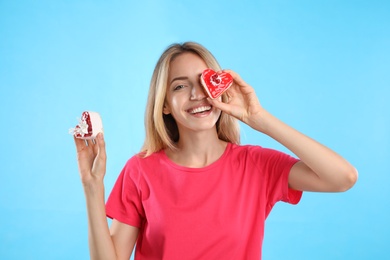 Photo of Concept of choice between healthy and junk food. Woman with cakes on light blue background
