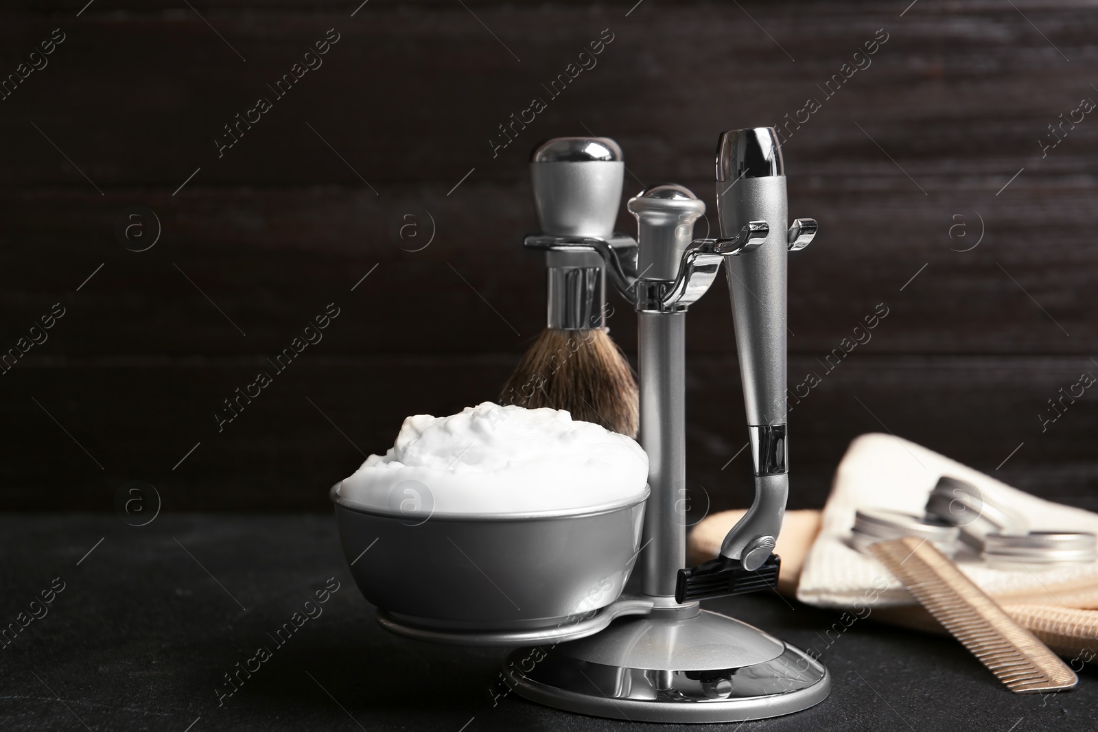 Photo of Shaving accessories on table against dark background with space for text