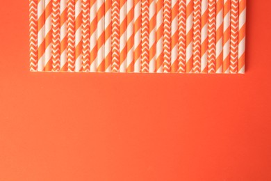 Photo of Many paper drinking straws on orange background, flat lay. Space for text