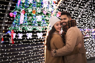 Photo of Lovely couple spending time together at Christmas fair