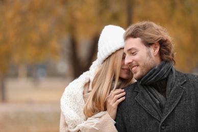 Young romantic couple in park on autumn day