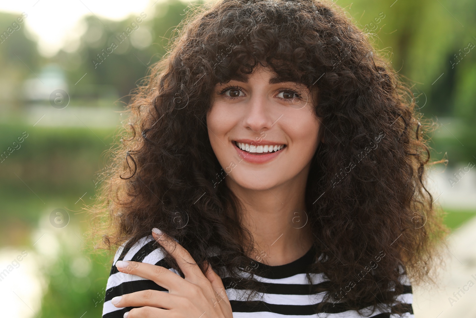 Photo of Portrait of beautiful woman outdoors. Attractive lady smiling and looking into camera