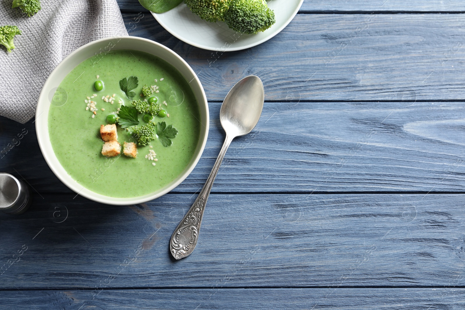 Photo of Fresh vegetable detox soup made of broccoli and green peas served on table, top view. Space for text