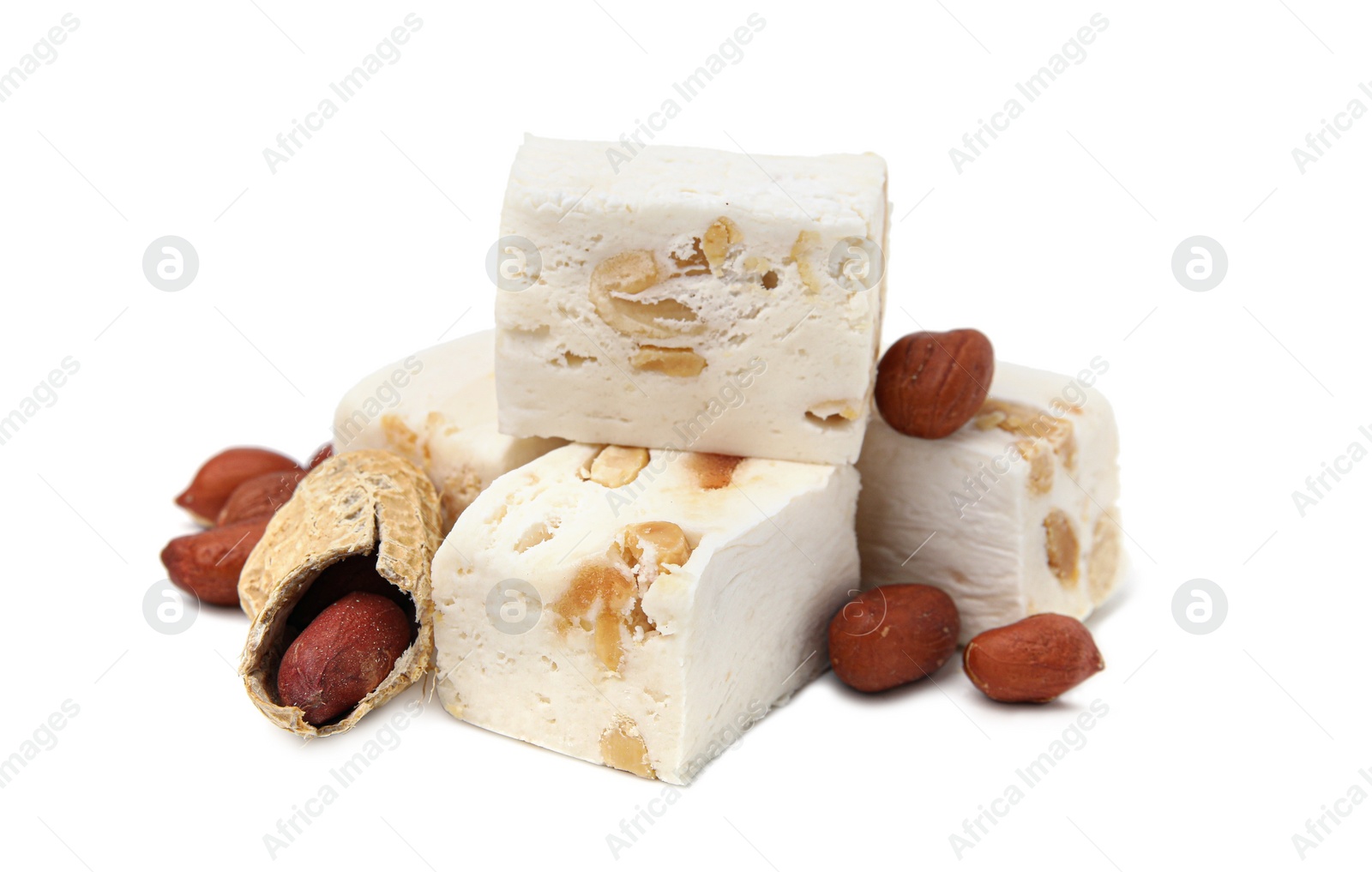 Photo of Pieces of delicious nougat and nuts on white background