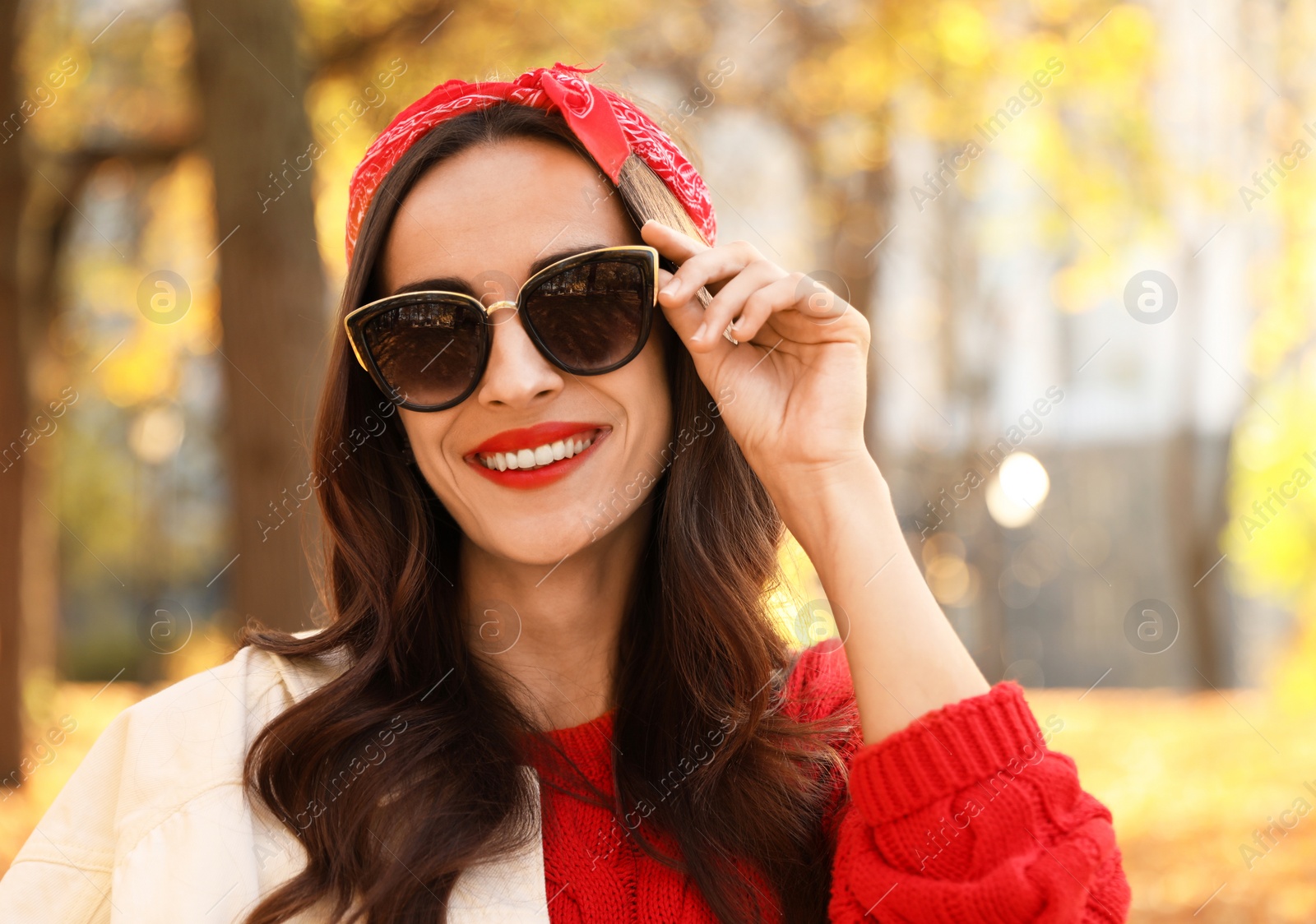 Photo of Beautiful woman wearing sunglasses in park. Autumn walk