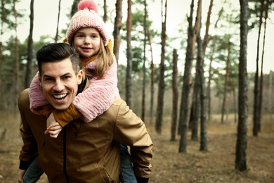 Photo of Man and his daughter spending time together in forest