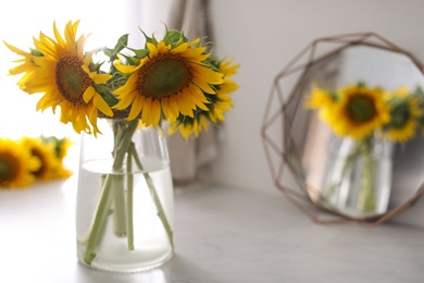 Photo of Vase with beautiful yellow sunflowers  on table, space for text