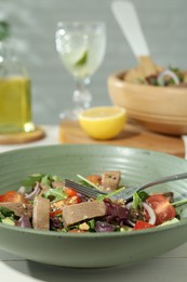 Photo of Delicious salad with beef tongue, vegetables and fork served on table. Space for text