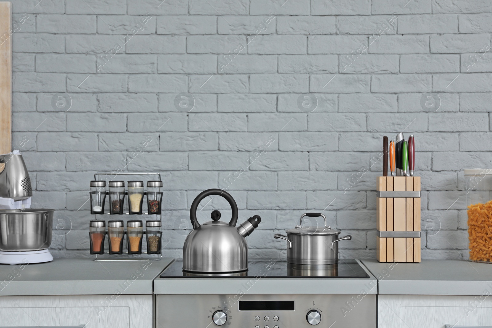 Photo of Modern kitchen interior with new furniture and different utensils