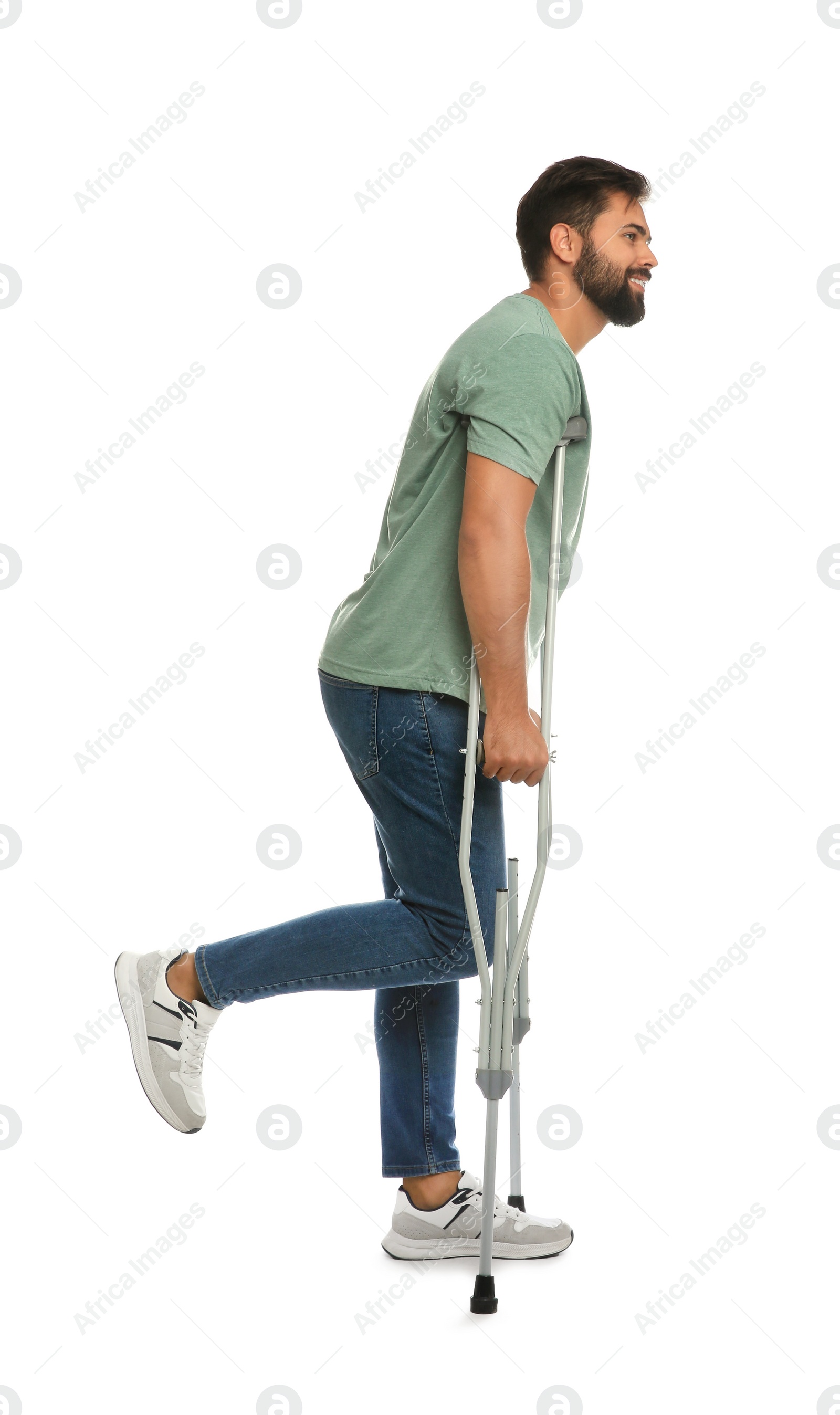 Photo of Young man with axillary crutches on white background