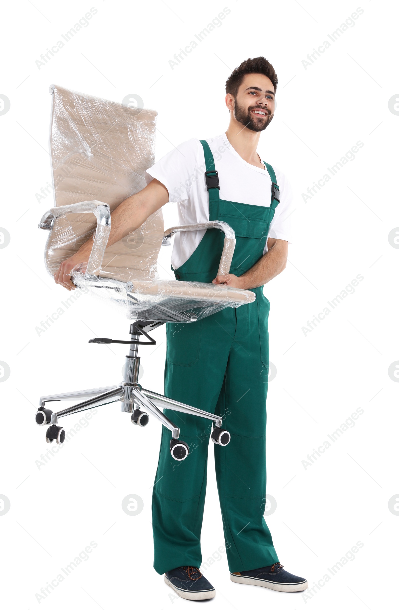 Photo of Young worker carrying office chair isolated on white. Moving service