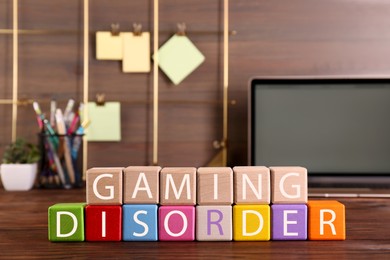 Photo of Phrase Gaming Disorder made of colorful cubes on wooden table