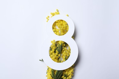 Photo of 8 March greeting card design with yellow mimosa flowers on white background, top view. Happy International Women's Day