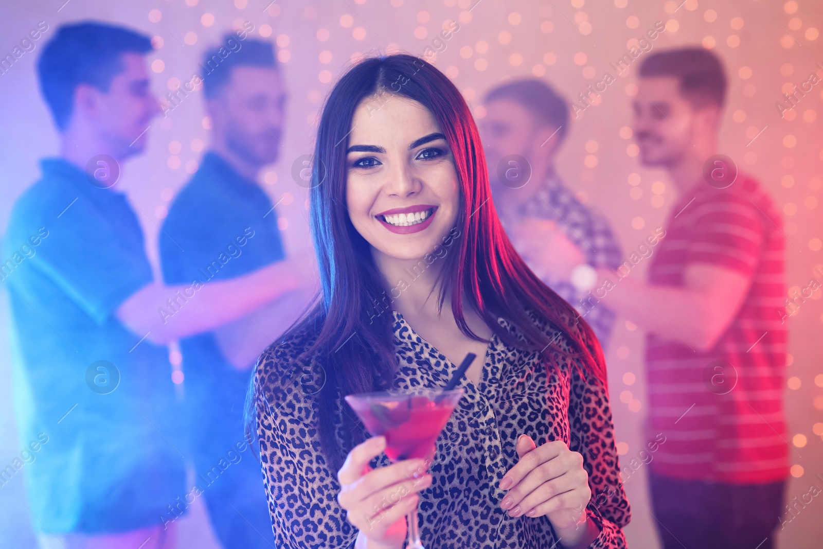 Photo of Beautiful young woman with glass of martini cocktail in bar