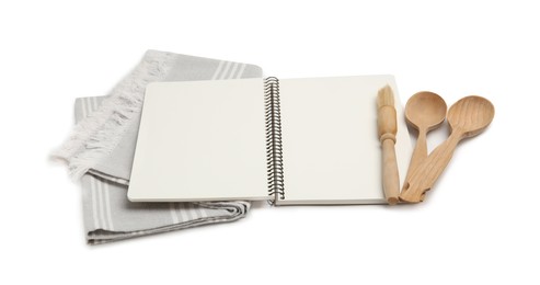 Photo of Blank recipe book, napkin and wooden utensils on white background. Space for text