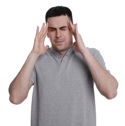 Photo of Young man suffering from headache on white background. Cold symptoms