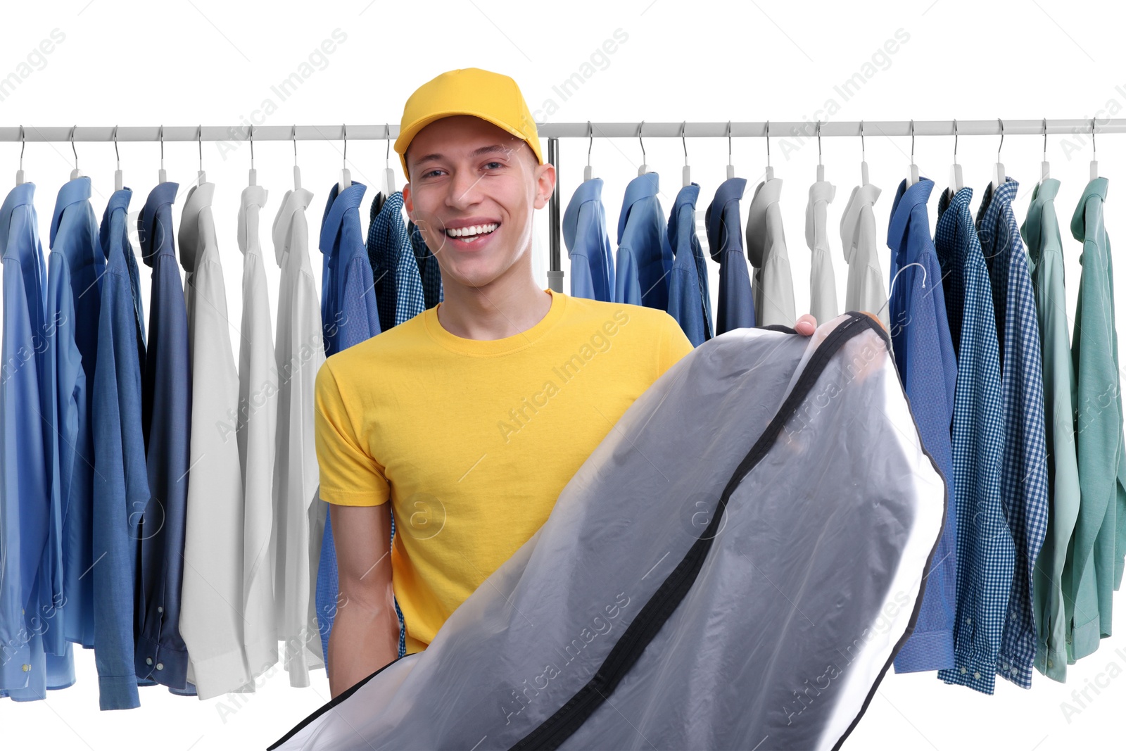 Image of Dry-cleaning delivery. Happy courier holding garment cover with clothes near wardrobe rack on white background