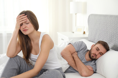 Photo of Unhappy young couple with relationship problems at home