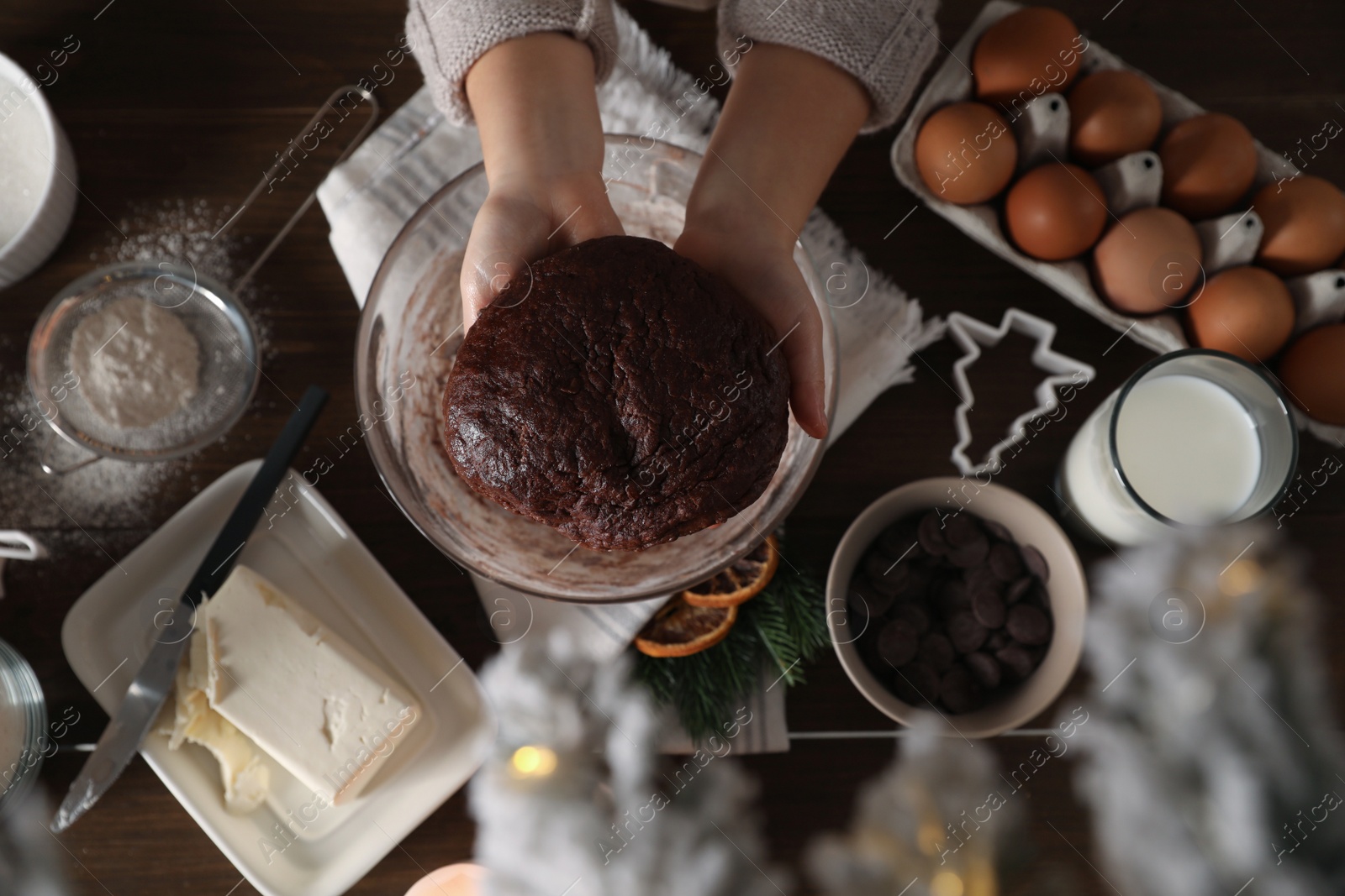 Photo of Little child making Christmas cookies at wooden table, top view