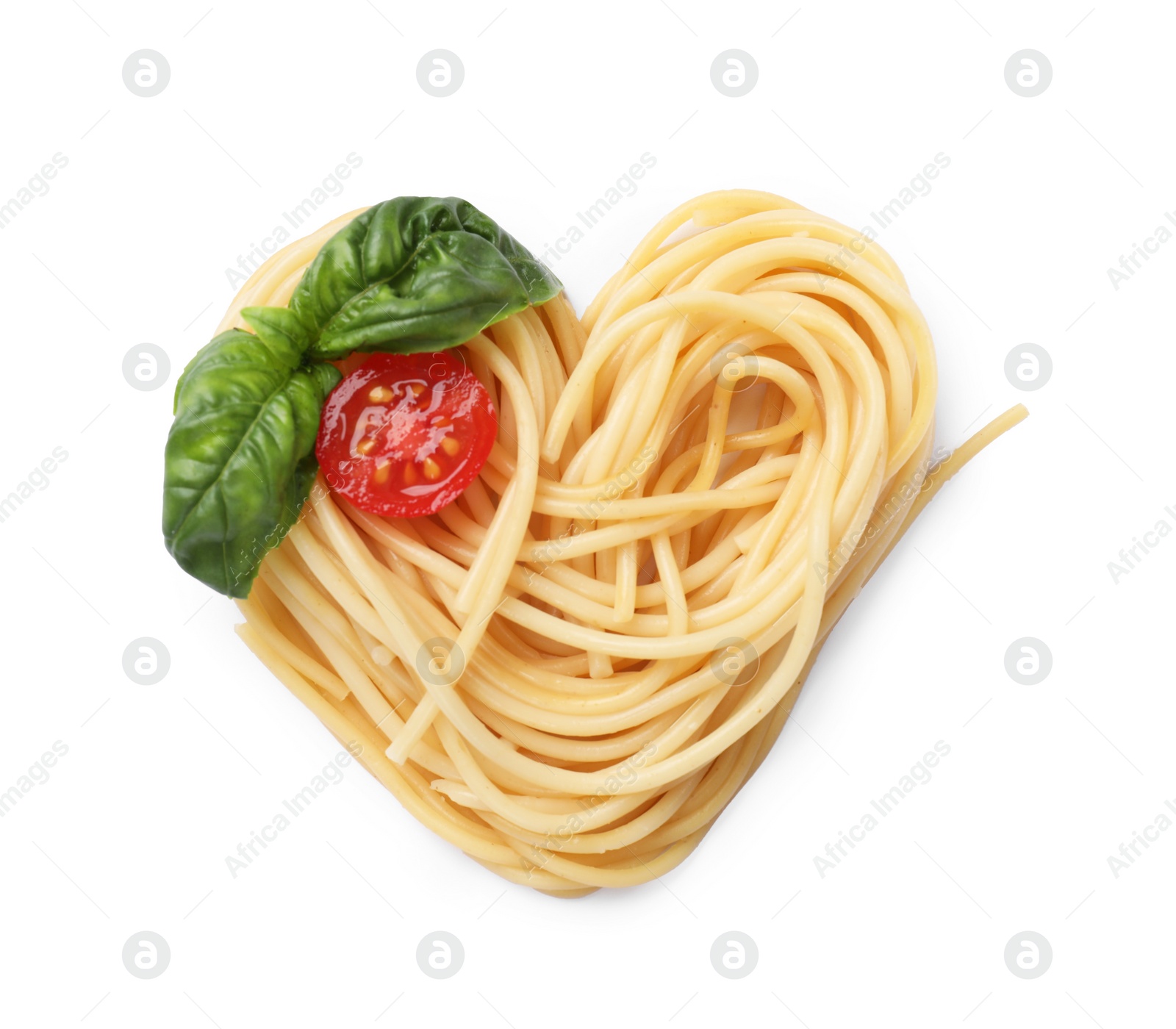 Photo of Heart made of tasty pasta, cut tomato and basil isolated on white