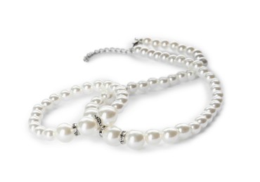 Photo of Elegant pearl necklace and bracelet on white background