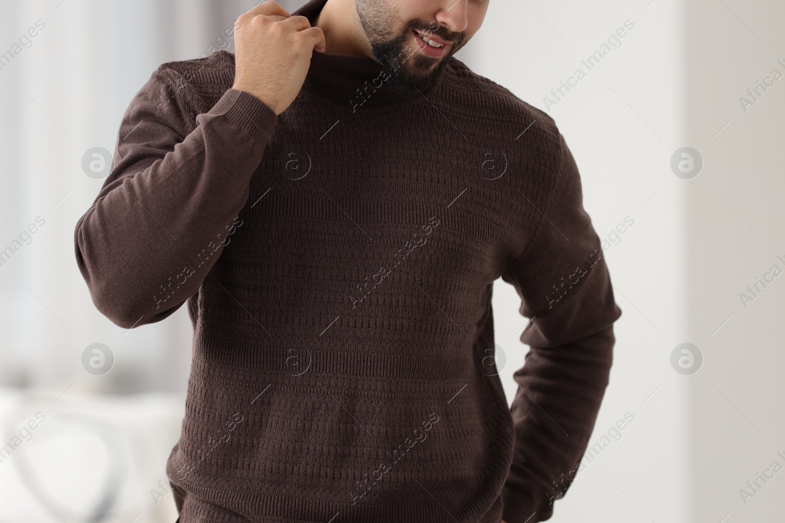 Photo of Man in stylish sweater against blurred background, closeup