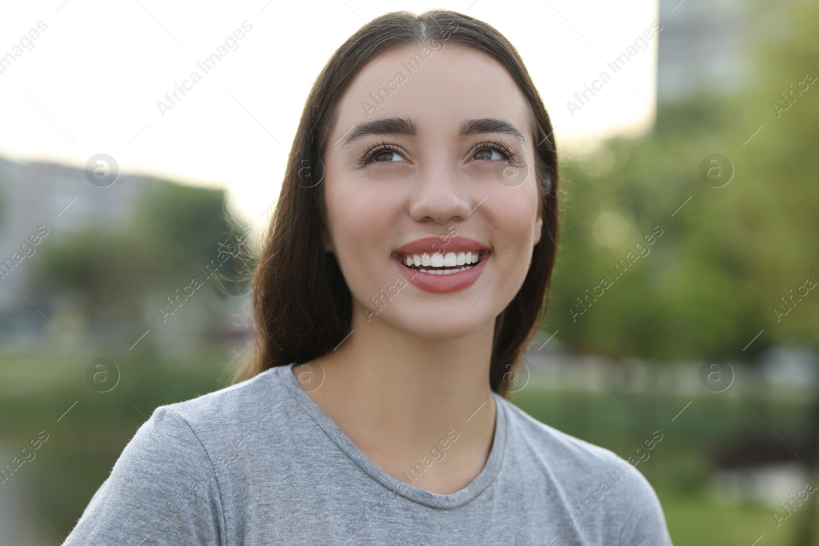 Photo of Portrait of beautiful woman outdoors. Attractive lady smiling and posing for camera