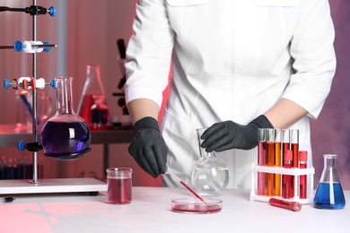 Scientist working with samples at table in chemistry laboratory