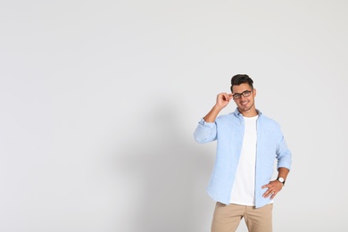 Portrait of handsome young man and space for text on white background