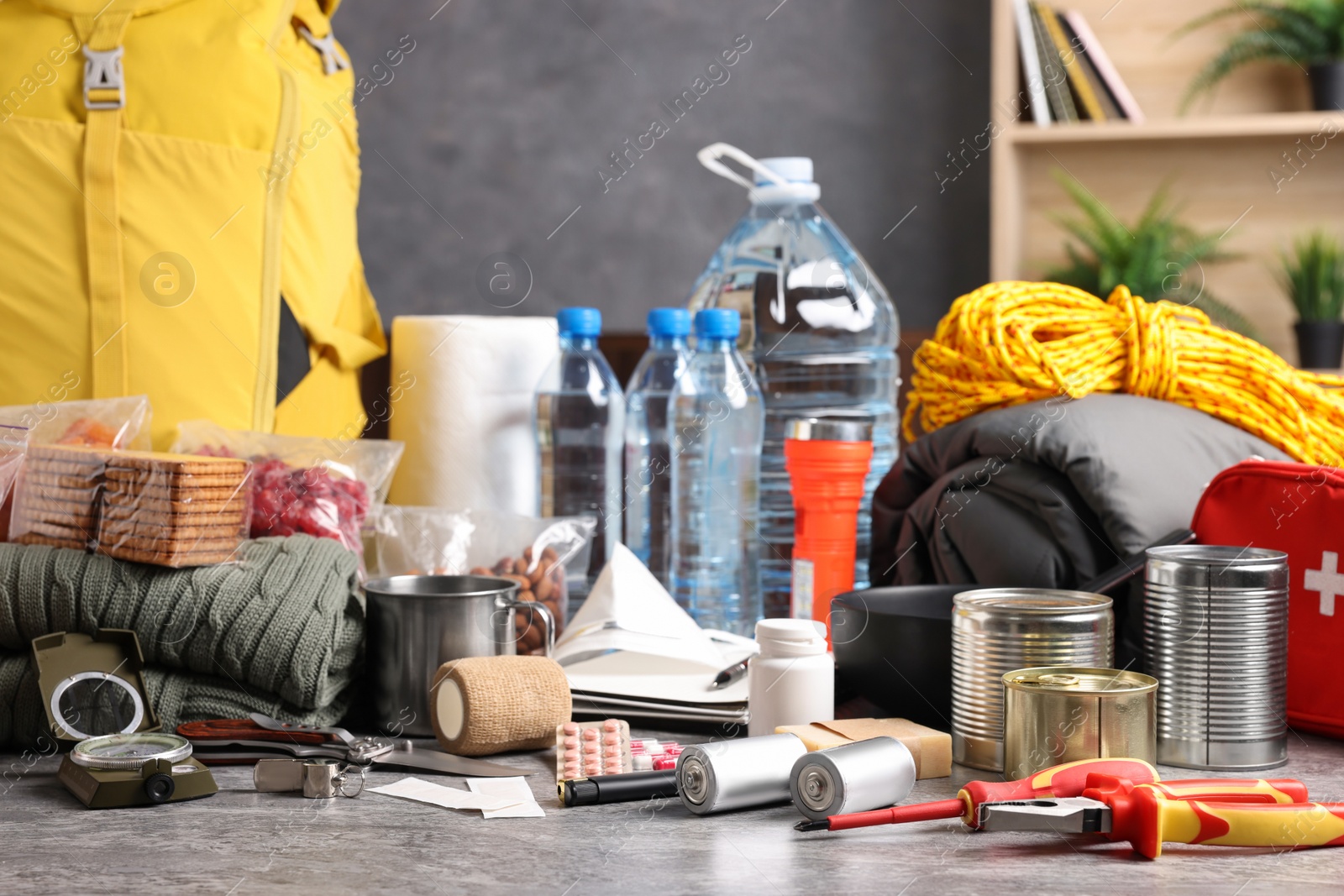 Photo of Disaster supply kit for earthquake on grey table indoors