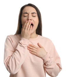 Young tired woman yawning on white background