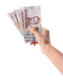 Woman holding Ukrainian money on white background, closeup