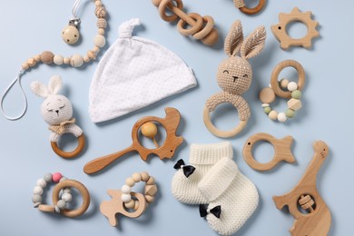 Different baby accessories on light blue background, flat lay