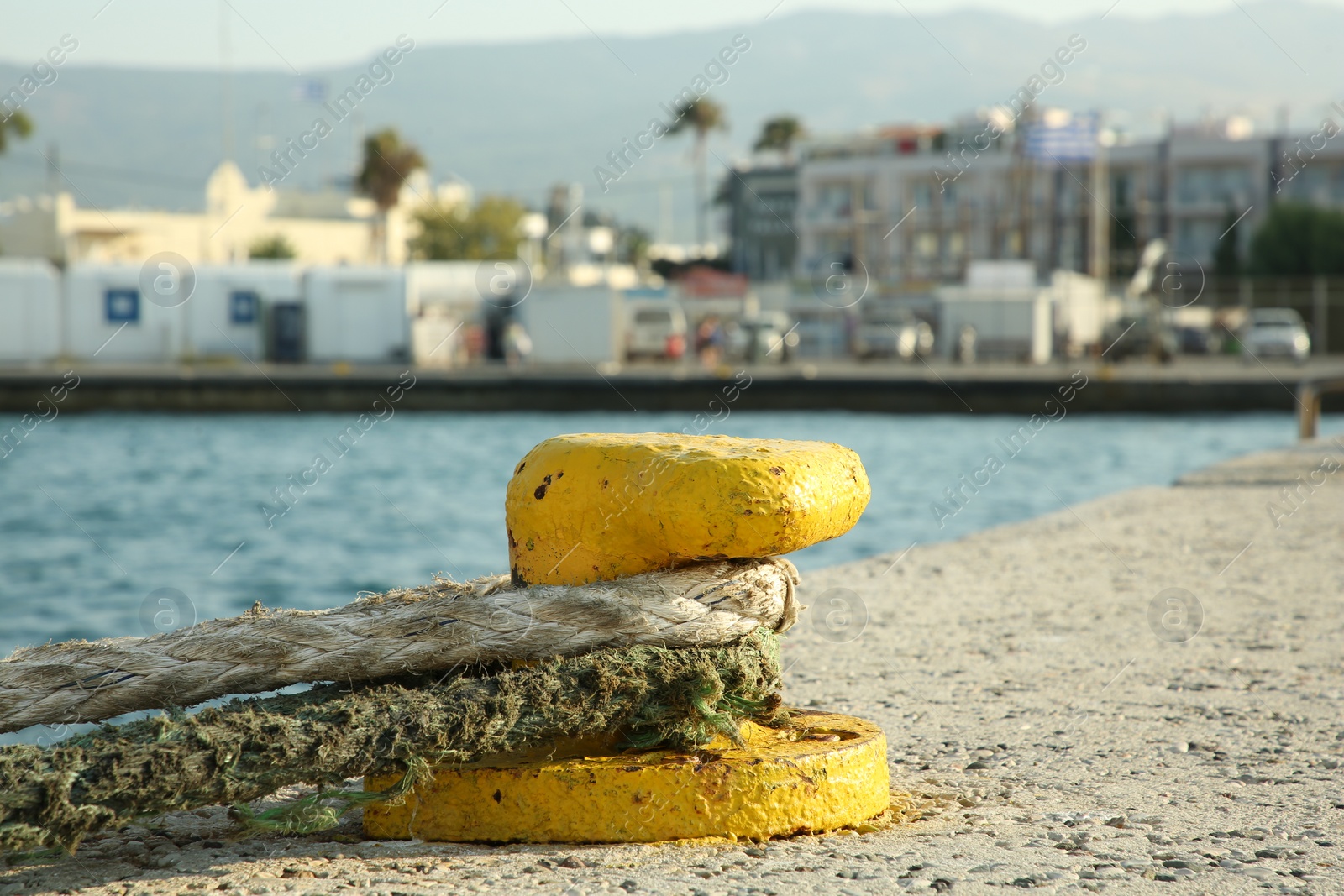 Photo of Mooring pole with rope in sea port