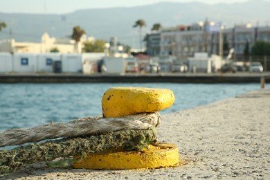 Mooring pole with rope in sea port