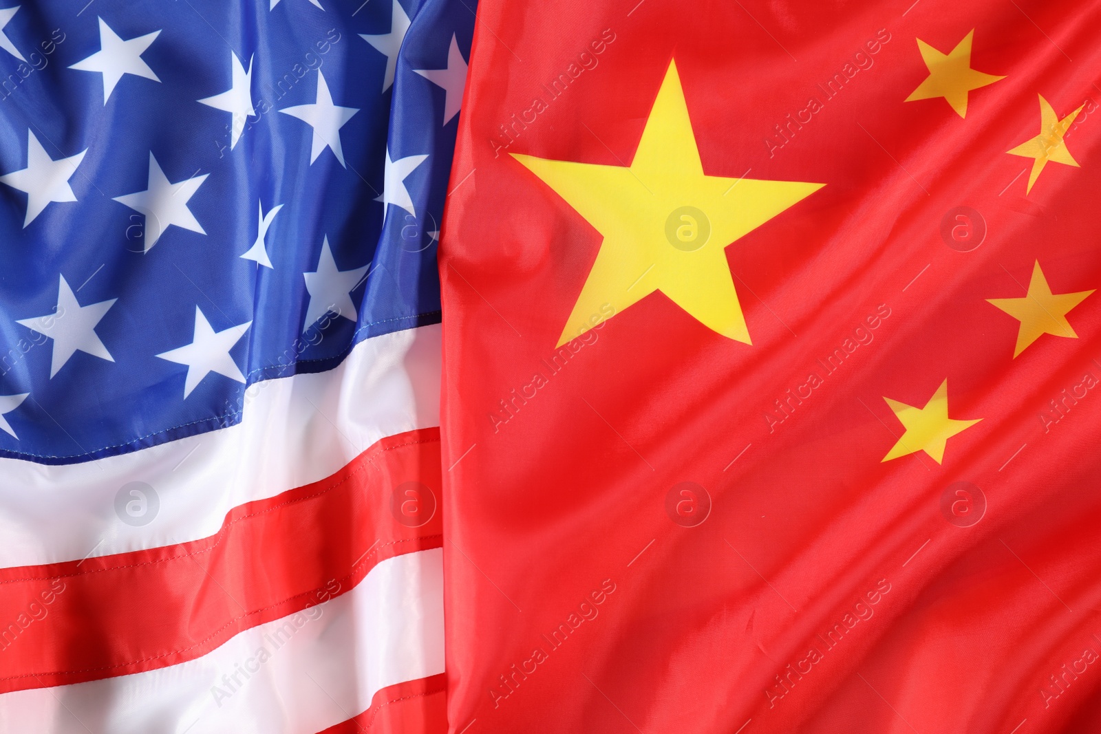 Photo of USA and China flags as background, top view. International relations