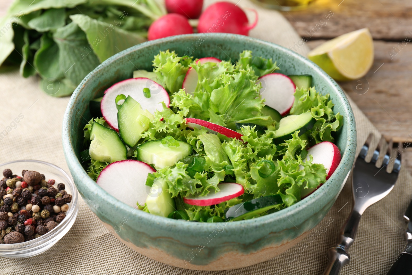 Photo of Delicious salad with radish in bowl served on table, closeup