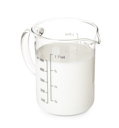 Fresh milk in measuring cup isolated on white